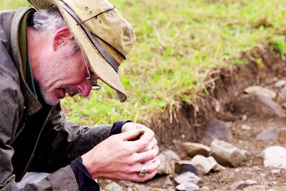 Thomas J. Finan examining finds at the Rock of Lough Key excavation
